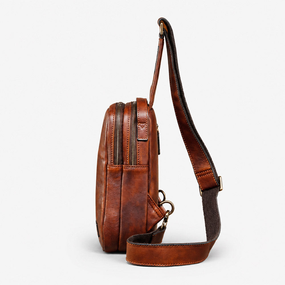 Side view of compact brown leather waist bag showing 8cm depth, layered zipper structure, and sturdy strap hardware