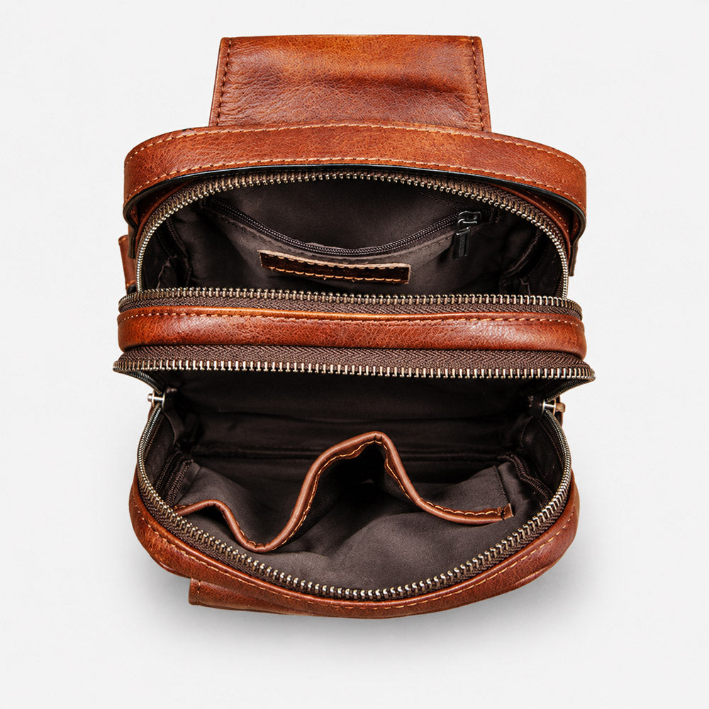 Open brown leather waist bag showing organized compartments for a 7-inch phone, wallet, cards, keys, and daily essentials